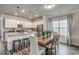 Eat-in kitchen featuring white cabinetry, granite countertops, a kitchen island, and a wooden dining room table at 269 Mayflower Dr., Calabash, NC 28467