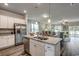 Kitchen featuring white cabinetry, granite countertops, stainless steel appliances, and an island with a double sink at 269 Mayflower Dr., Calabash, NC 28467