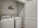 Functional laundry room with a washer, dryer, and wire shelving at 269 Mayflower Dr., Calabash, NC 28467