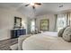 Bright main bedroom features an elegant dresser, hardwood floors, and artwork at 269 Mayflower Dr., Calabash, NC 28467