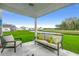 Outdoor patio with comfortable seating overlooking a pond and greenery at 269 Mayflower Dr., Calabash, NC 28467