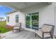 Covered patio showcasing outdoor seating and view through sliding glass door at 269 Mayflower Dr., Calabash, NC 28467