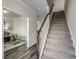 Carpeted staircase next to an open office space with hardwood floors and white trim at 269 Mayflower Dr., Calabash, NC 28467