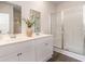 Bright bathroom featuring double sinks, a large mirror, and a glass-enclosed shower at 2884 Riverboat Way, Conway, SC 29526