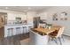 Dining area with a wooden table and wicker chairs, complemented by stylish decor and stainless appliances at 2884 Riverboat Way, Conway, SC 29526