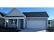 Charming single-story home features a two-car garage and a cozy front porch, perfect for relaxation at 2884 Riverboat Way, Conway, SC 29526