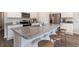 Kitchen island featuring granite countertops, barstool seating, and stainless steel appliances in a modern design at 2884 Riverboat Way, Conway, SC 29526
