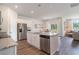 Modern kitchen with white cabinets, granite countertops, stainless steel appliances, and a center island at 2884 Riverboat Way, Conway, SC 29526