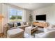 Inviting living room with a large window, comfortable seating, and a stylish media cabinet for relaxing at 2884 Riverboat Way, Conway, SC 29526
