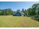 Beautiful backyard with lush green grass and a view of the home's exterior at 294 Field Loop Rd., Georgetown, SC 29440