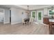View of dining room with modern light fixture, wood table and wood-look flooring at 294 Field Loop Rd., Georgetown, SC 29440