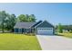 Charming single-story home with blue siding, a two-car garage, and a well-manicured lawn at 294 Field Loop Rd., Georgetown, SC 29440