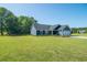 The front exterior of a blue single-story home with a well-maintained lawn at 294 Field Loop Rd., Georgetown, SC 29440