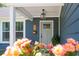 Close up of a gray front door framed by a white pillar and beautiful landscaping at 294 Field Loop Rd., Georgetown, SC 29440