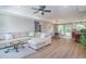 Open concept living room with wood floors, neutral tones, and dining area at 294 Field Loop Rd., Georgetown, SC 29440