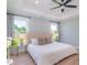 Light-filled main bedroom featuring a ceiling fan and two bright windows at 294 Field Loop Rd., Georgetown, SC 29440