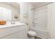 Modern all-white bathroom featuring a tub, shower, and vanity with storage at 296 Clear Lake Dr., Conway, SC 29526