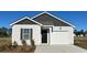 Charming single-story home featuring a one-car garage, black door, and complementary white and gray siding at 296 Clear Lake Dr., Conway, SC 29526