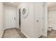 Inviting hallway with wood-look flooring, a white door, and decorative mirror enhancing the home's appeal at 296 Clear Lake Dr., Conway, SC 29526
