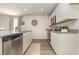 Modern kitchen featuring stainless steel appliances, granite countertops, and white cabinetry for a clean look at 296 Clear Lake Dr., Conway, SC 29526