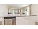 Open concept kitchen showcasing stainless steel dishwasher, white cabinets, and granite countertops at 296 Clear Lake Dr., Conway, SC 29526