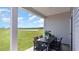 Relaxing covered patio featuring a table and chairs set overlooking a lush green yard and scenic pond views at 304 Clear Lake Dr., Conway, SC 29526