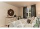 Bright bedroom with a rustic dresser, stylish mirror and large window with patterned drapes at 304 Clear Lake Dr., Conway, SC 29526