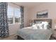 Bright bedroom featuring a large window, patterned drapes, and a comfortable bed with decorative pillows at 304 Clear Lake Dr., Conway, SC 29526