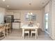 Dining area adjacent to kitchen with stainless steel refrigerator and an outdoor view through the window at 304 Clear Lake Dr., Conway, SC 29526