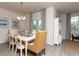 Well-lit dining area with a chandelier, views to the exterior, and an adjacent living room at 304 Clear Lake Dr., Conway, SC 29526