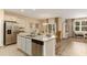 Bright kitchen with granite countertops, stainless steel appliances, and a spacious island with a sink and dishwasher at 304 Clear Lake Dr., Conway, SC 29526