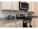 Modern kitchen features granite countertops, stainless steel appliances, and ample cabinet space for storage at 304 Clear Lake Dr., Conway, SC 29526