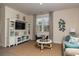 Comfortable living room showcasing a sofa, large window, entertainment center, and coastal-inspired decor at 304 Clear Lake Dr., Conway, SC 29526