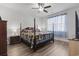 Comfortable bedroom with a four-poster bed, hardwood floors, a ceiling fan, and natural light at 3056 Skylar Dr., Myrtle Beach, SC 29577