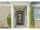 Inviting front entrance with brick accents and a glass door, flanked by manicured greenery at 3056 Skylar Dr., Myrtle Beach, SC 29577