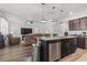 Modern kitchen with an island bar overlooking the living room featuring recessed lighting and hardwood floors at 3056 Skylar Dr., Myrtle Beach, SC 29577