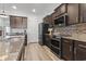 Modern kitchen featuring stainless steel appliances, granite countertops, and dark cabinetry at 3056 Skylar Dr., Myrtle Beach, SC 29577
