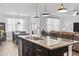 Open concept kitchen featuring a spacious island with granite countertops, stainless steel appliances, and hardwood floors at 3056 Skylar Dr., Myrtle Beach, SC 29577