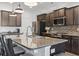 Beautiful kitchen with a spacious island featuring dark wood cabinets, stainless steel appliances, and granite countertops at 3056 Skylar Dr., Myrtle Beach, SC 29577