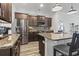 Well-equipped kitchen featuring dark wood cabinets, stainless steel appliances, granite countertops, and a stylish backsplash at 3056 Skylar Dr., Myrtle Beach, SC 29577