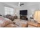 Well-lit living room with plush seating, a large window, and modern entertainment center at 3056 Skylar Dr., Myrtle Beach, SC 29577