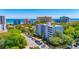 Aerial view featuring the ocean and condo building surrounded by mature trees at 311 71St Ave. N # 5A, Myrtle Beach, SC 29572