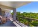 Relax on this outdoor balcony with comfortable seating and a view of lush greenery at 311 71St Ave. N # 5A, Myrtle Beach, SC 29572