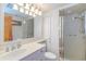 Well-lit bathroom featuring white cabinets, a modern vanity, a glass-enclosed shower, and fixtures at 311 71St Ave. N # 5A, Myrtle Beach, SC 29572