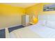 Charming bedroom with a single bed, white furniture and yellow walls, creating a warm and inviting atmosphere at 311 71St Ave. N # 5A, Myrtle Beach, SC 29572