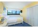 Inviting bedroom with a single bed, yellow walls, a large window and closet space, perfect for a comfortable stay at 311 71St Ave. N # 5A, Myrtle Beach, SC 29572