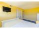 Bright bedroom with yellow walls, a large window and closet space, providing ample storage and natural light at 311 71St Ave. N # 5A, Myrtle Beach, SC 29572