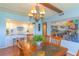 Bright dining room featuring wood table with stone accents, chandelier, and an open view to the kitchen at 311 71St Ave. N # 5A, Myrtle Beach, SC 29572
