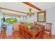 Cozy dining area with a wooden table, a chandelier, and beams on the ceiling that lead into an open living area at 311 71St Ave. N # 5A, Myrtle Beach, SC 29572