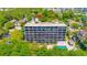 Aerial view of an apartment building with a pool and tree lined surroundings at 311 71St Ave. N # 5A, Myrtle Beach, SC 29572